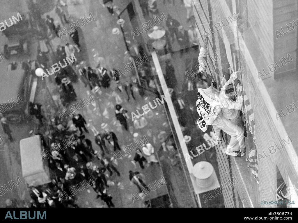 John "Jammie" Reynolds (born 1890 or 91 - ?) was an American daredevil. Little is known about early life, what became of him once he stopped performing or even his real name. An acrobat and juggler, he was known by many names - Daredevil Johnny, Daredevil Jack, the Climbing Wonder, The Lizard, the Human Spider, and the Human Fly. A newspaper article from 1922 claims he began performing at the age six in Buffalo, balancing on one foot from a flagpole 140 feet in the air. His first major stunt came at age 12 when he climbed up the side of the Old South Building in Boston, balancing atop four chairs and five tables on a plank projected over the side of the building. He gave similar performances in New York on its iconic Flatiron building, and at home in Philadelphia. Reynolds was arrested several times after his performances accused of "unlawful assembly". A stunt performer, often referred to as a stuntman, or daredevil, is someone who performs dangerous stunts, often as a career. Photographed by the National Photo Company, circa 1912-30.