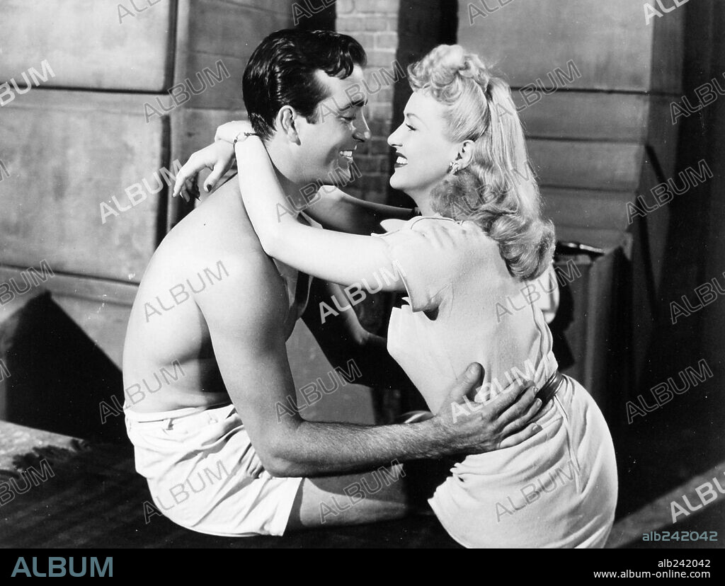 BETTY GRABLE and JOHN PAYNE in FOOTLIGHT SERENADE, 1942, directed by GREGORY RATOFF. Copyright 20TH CENTURY FOX.