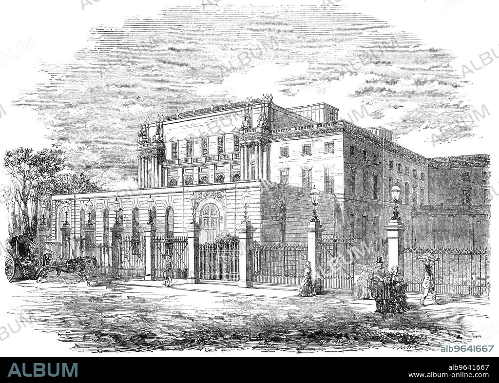 Exterior of the New Ball-Room, Buckingham Palace, 1856. 'This is a handsome addition to the southern side of the main body of the Palace, projecting from the side known...as the Dining-room front...The throne end of the room abuts upon the garden...The front is relieved by a projection at each end, having two pillars each, and being surmounted by trophies at the angles. Five windows light this front. Above them there is a frieze, enriched with a scroll ornament, which gives a finish to the building, which would otherwise look plain. The height of this room externally cannot be less than fifty feet; whilst its length is more than one hundred and twenty feet...The whole of this side of the Palace from the Park front has lately been much improved by the addition of a new railing, with stone piers; and some of the open spaces have been planted with shrubs and evergreens'. From "Illustrated London News", 1856.