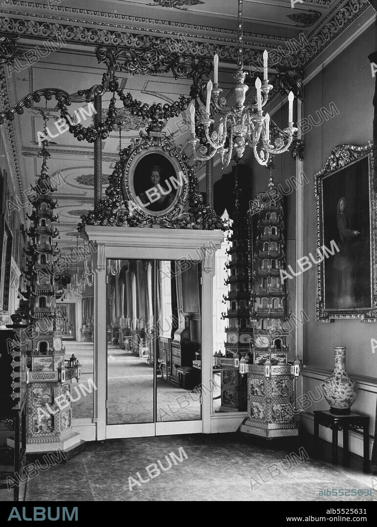 The Silver Jubilee Interiors Of Buckingham Palace - Principal Corridor, south end, showing portrait of Queen Victoria by Sir George Nayter, R.A., set in looking-glass panels above mirror doors, and Chinese porcelain pagodos from the Royal Pavilion, Brighton. September 09, 1937. (Photo by Topical Press).