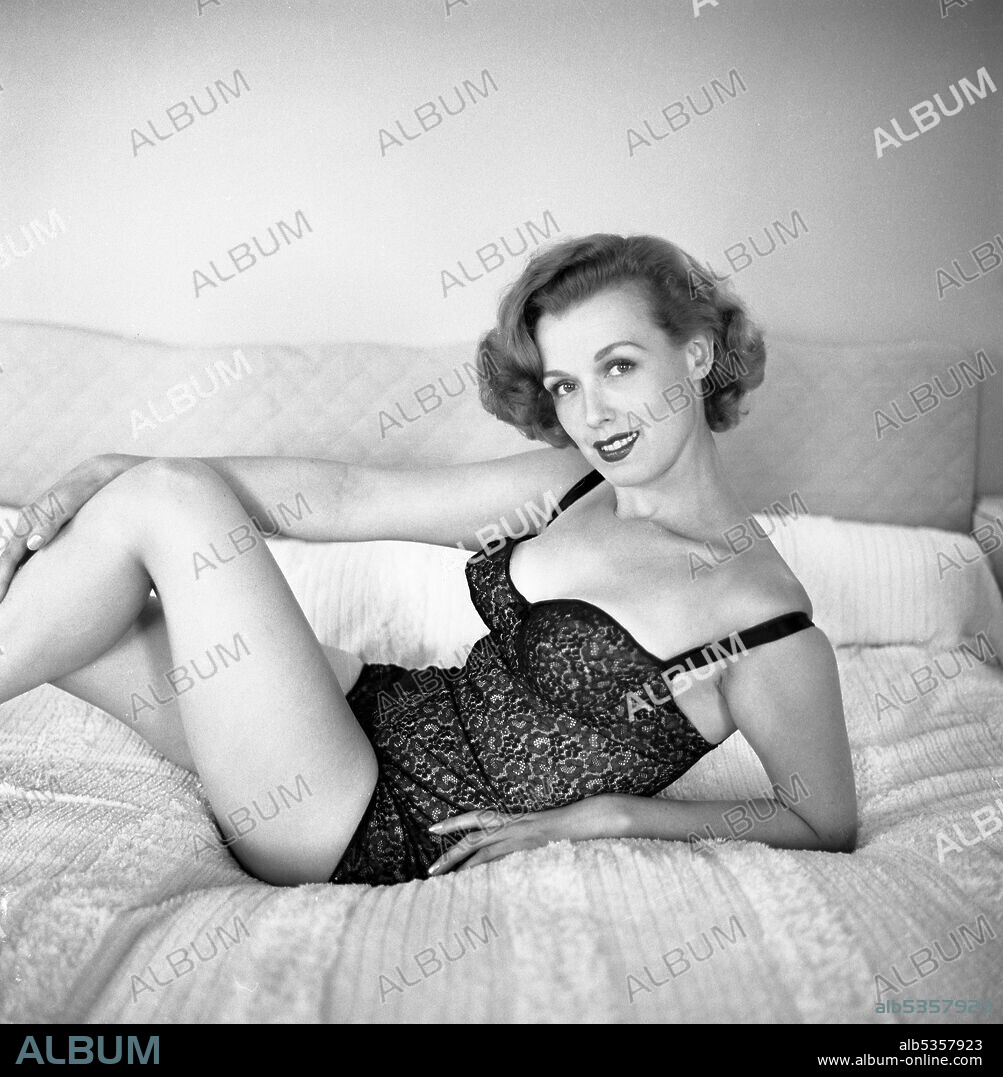 NOREEN NASH. Circa 1950, Hollywood, California, USA: 1940's American actress and model NOREEN NASH wearing lingerie and looking seductive in the bedroom.