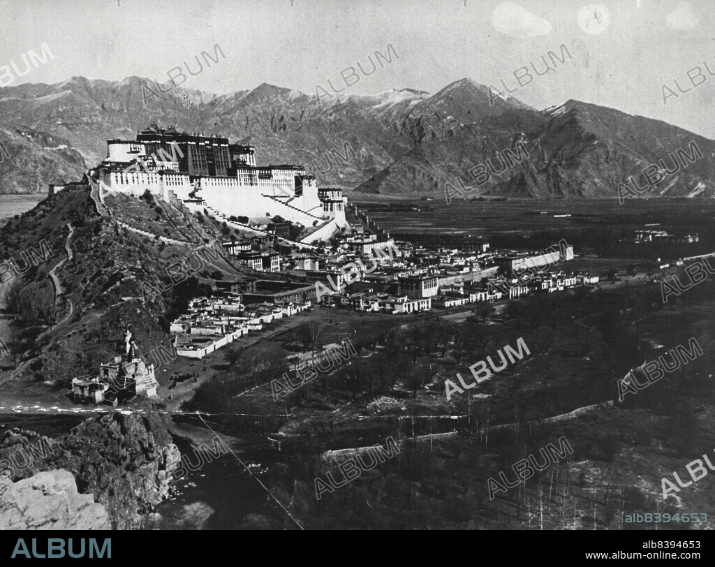 Lhasa, Capital Of Tibet: Potala - A general view of the imposing residence of the Dalai Lama, in Lhasa, the capital of Tibet. With its vast inward-sloping walls broken only in the upper parts by straight rows of many windows, and its flat roofs of many levels, it has the appearance of a fortress dominating the city. The central part of the group of buildings is called The Red Palace from its crime on color which distinguishes it from the rest; it stands far higher than the rest and contains the principal halls and shrines of the Dalai Lama. March 5, 1953. (Photo by Camera Press).