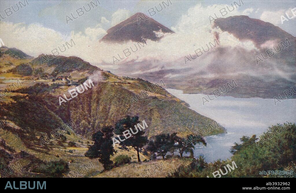 'Central America. Ringed in by peaks of the Guatemalan Cordillera, Lake Atitlan fills a crater 1,000 feet deep near the volcanic cones of San Pedro and Atilan. It possesses no visible outlet for its waters', c1920. Lake Atitlan is located in the Guatemalan Highlands, by the Sierra Madre mountains. Its name means at the water in Aztec language. The lake is one of the deepest in Central America and is renowned as one of the most beautiful national and international attractions. From Geographical Magazine, Volume 2, c1920.
