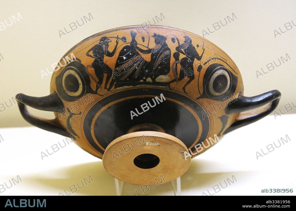 Kylix decorated with a symposium scene depicting a reclined Dionysos with drinking horn  and dancing satyrs. Made in Athens. From Etruria. Leafless Group. 540-520 BC. National Archaeological Museum. Naples. Italy.