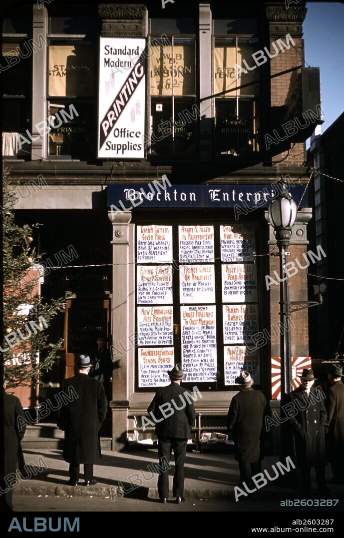 Men reading headlines posted in street-corner of Brockton Enterprise newspaper office, Brockton, Massachusetts, USA.
