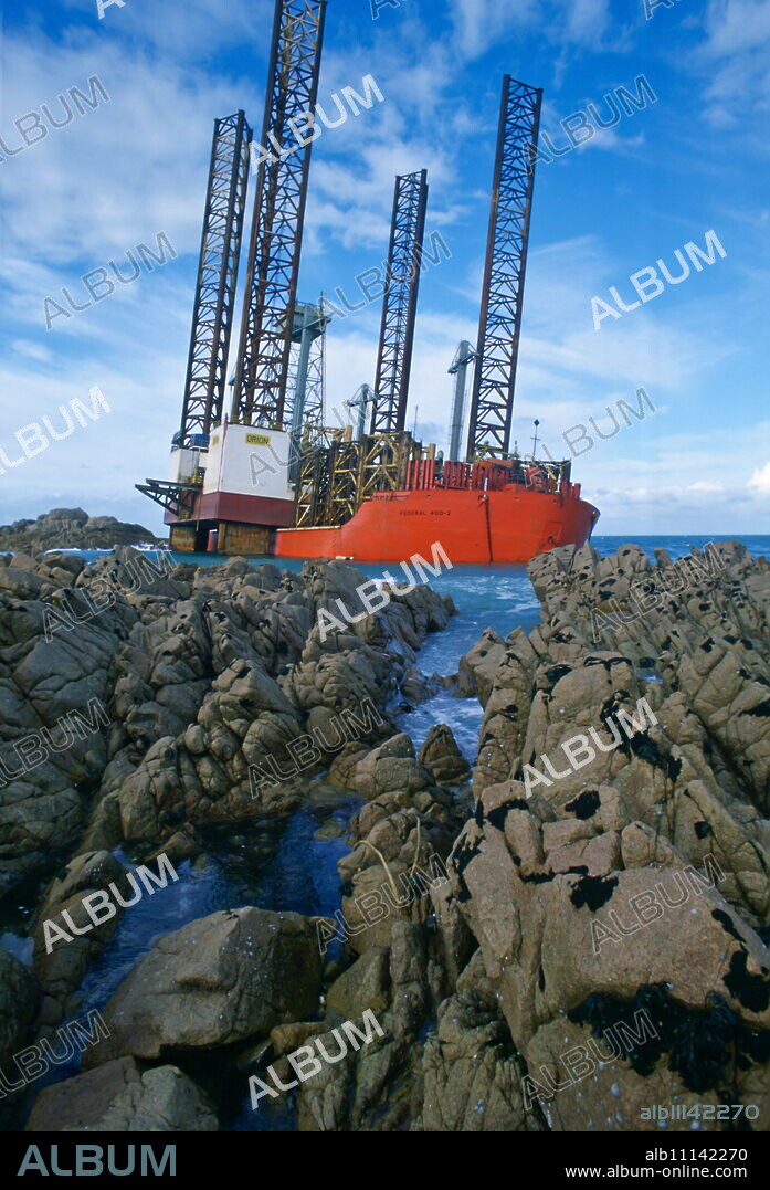 Oil rig aground in Grandes Rocques Bay, Guernsey, Channel Islands.