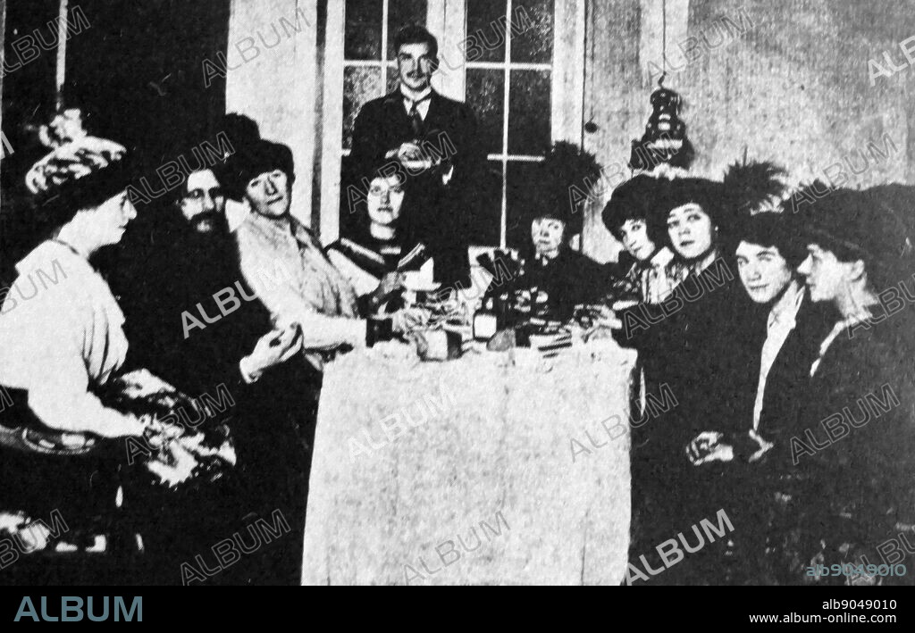 Gregory Rasputin with his daughter Maria (in front of standing man) meeting with female admirers in St Petersburg, Russia 1915. Grigori Yefimovich Rasputin (1869 1916) was a Russian peasant, mystical faith healer, and trusted friend of the family of Nicholas II, the last Tsar of Russia. He became an influential figure in Saint Petersburg, especially after August 1915, when Nicholas took command of the army fighting in World War I. Advising his wife Alexandra Feodorovna.