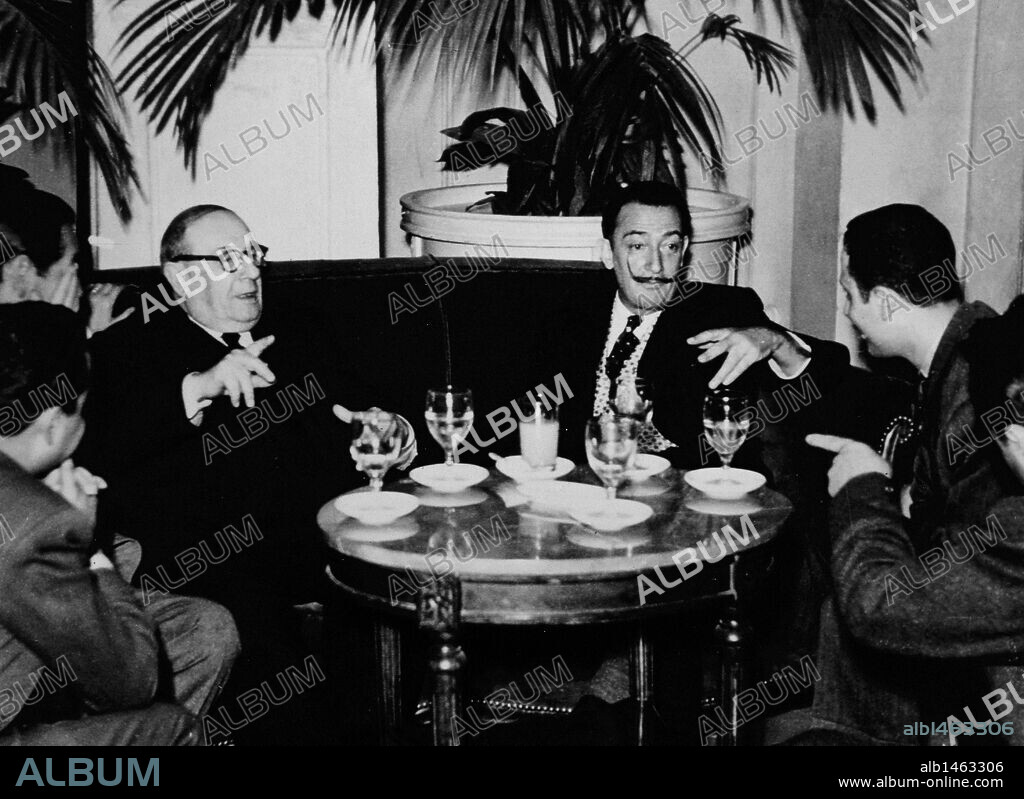 The spanish surrealist painter Salvador Dali (1904-1989) met with businessman cinemas and bulls Pedro Balan_a. 1953. Barcelona. Catalonia. Spain.