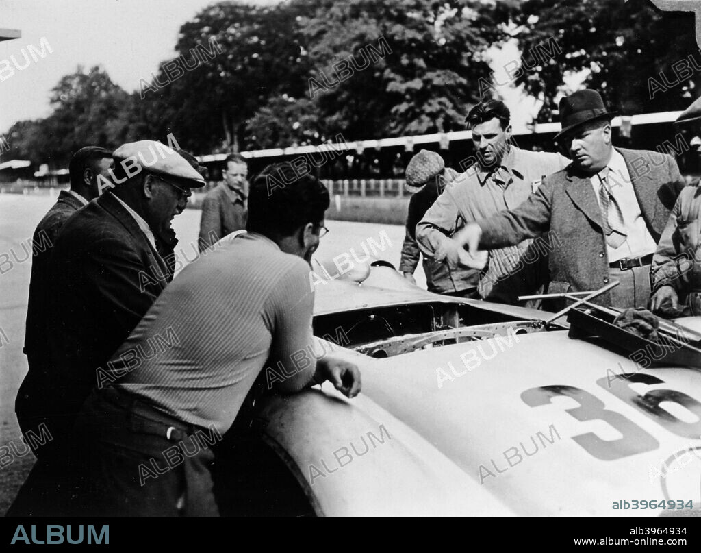 Alfred Neubauer with a Mercedes, Avus motor racing circuit, Berlin, Germany, 1938. Neubauer (right, wearing the hat), took over as manager of the Mercedes-Benz racing team, bringing in many innovative practices and presiding over its many successes until 1955.