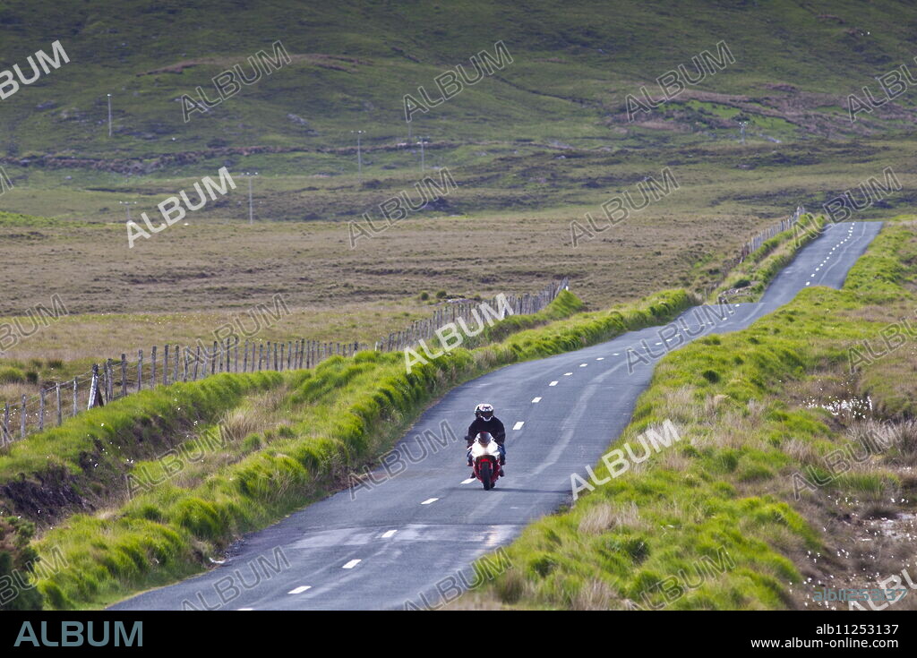 Motorcyclist on Kylemore Pass in Connemara National Park, County Galway, Ireland.