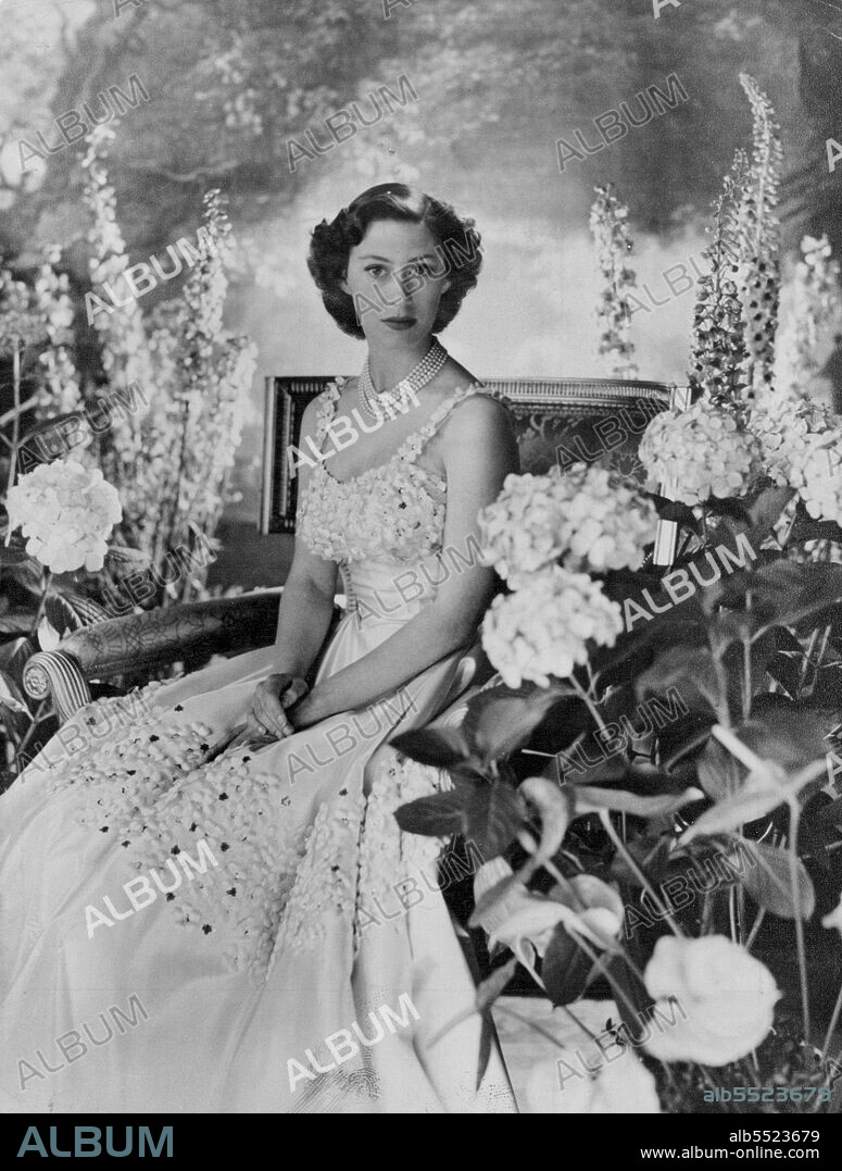Princess Margaret - A 21 St. Birthday Portrait - This 21st Birthday Portrait of Princess Margaret was made by Cecil Beaton in the music room of Buckingham Palace.
Her Royal Highness wears a five-rope pearls necklace above her dress of white taffeta. Appliqued petals and silver sequence form the flowers which decorate bodice and shoulder straps and are carried band around the full-length skirt. 
Princess Margaret celebrates her birthday anniversary August 21st. June 09, 1953. (Photo by Cecil Beaton, United Kingdom Information Service).