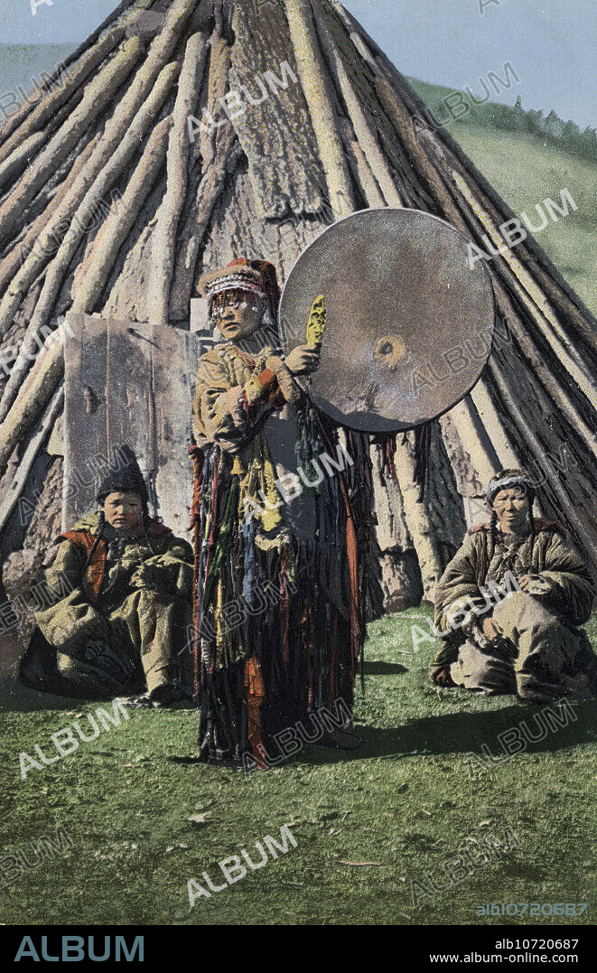 SERGEI IVANOVICH BORISOV. Altai Shaman with Tambourine in Front of a Traditional Dwelling (Chaadyr), 1911-1913. From a collection of color postcards of the Altay, or Altai, Mountains region of southern Siberia early in the 20th century. In 1907, Borisov began his expedition in the Altay Mountains, which lasted until 1911. He took around 1,500 photographs during this expedition, which, upon his return to Barnaul, he presented to the public through the use of a magic lantern. The photographs depict views of nature in remote corners of the Altay Mountains and the Altay and Kazakh peoples indigenous to this region. Borisov offered the photographs to various European publishers for the production of postcards. Altai State Regional Studies Museum.