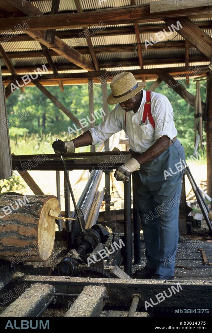 Man operating a sawmill at Agrirama, an historic village and museum of agriculture, in Tifton, Georgia.