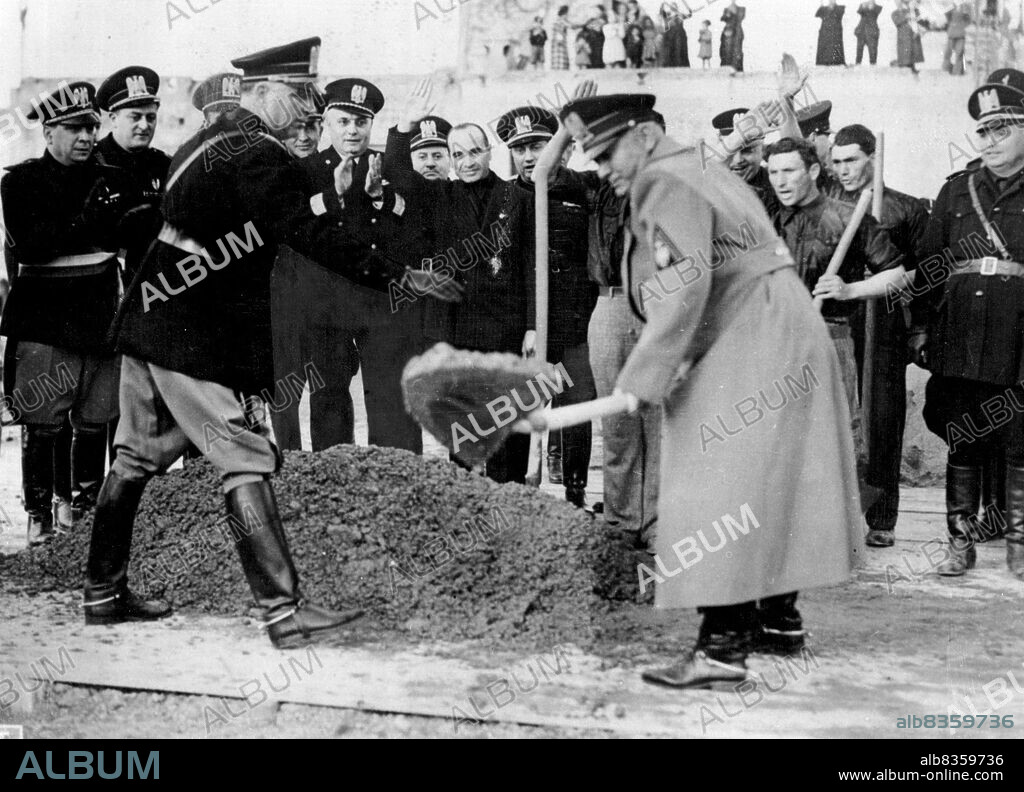 Mussolini In Southern Italy - Signor Mussolini photographed as he used a shovel with Vigour when he inaugurated the work of the building of a newpeople's houe at Crotone during his visit to Calabria, in Southern Italy. Fascist chiefs and workmen are seen applauding the Duce. April 03, 1939. (Photo by Keystone).