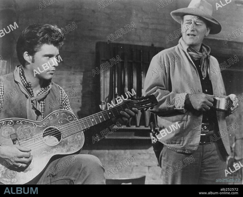 JOHN WAYNE and RICK NELSON (RICKY) in RIO BRAVO, 1959, directed by HOWARD HAWKS. Copyright WARNER BROTHERS.