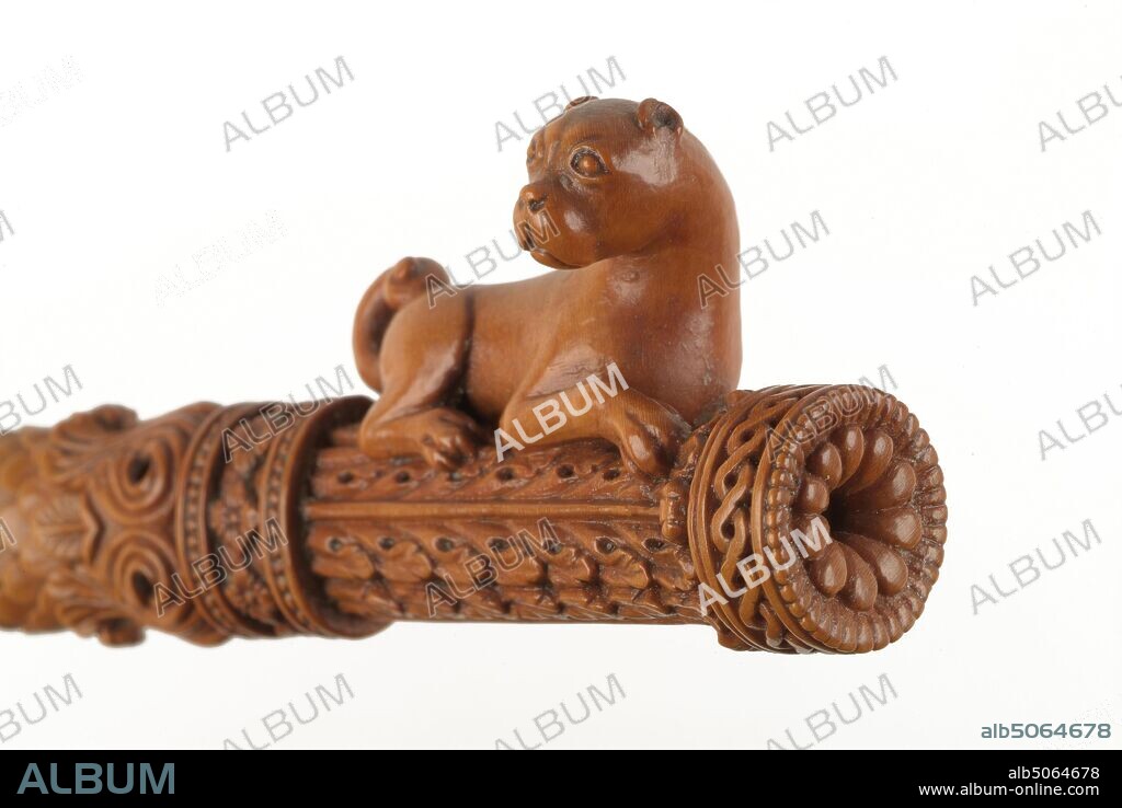 Knitting Sheath, 1600-1750 Knitting sheaths supported the weight of the knitting and stopped stitches slipping off the bottom of a double-ended needle. They were generally worn in the belt, on the right side, in a sloping position.They ranged from crudely whittled affairs to masterpieces of 'fine art', and were usually individually made and decorated by their makers to give as love tokens. This 18th century, boxwood, knitting sheath is widely acknowledged as a masterpiece of carving. It was probably made in France or Italy. The sheath does not appear to have been used and it has doubtless always been cherished as a work of art rather than as a functional object. Social history, Wood, Animal, Dog, Needlecraft, Treen.