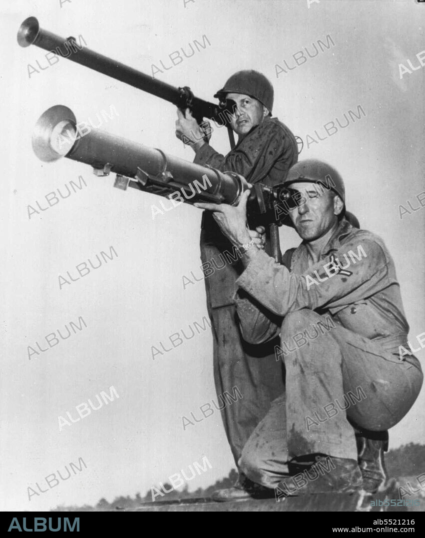 Big Brother -- The larger of the two bazookas above is the 3.5 inch rocket that has recently been thrown into the battle in Korea. On its first day of action it knocked out eight big tanks. It is the most effective anti-tank weapon available having the ability to penetrate about eleven inches of armor plate, It's the "Big Brother" to the 2.36 bazooka shown being held (at top) by Private Leroy McCargell of Liberty Grove, Md. Holding the 3.5 is PFC Matthew Keppinger of Havre De Grace. July 28, 1950. (Photo by AP Wirephoto).