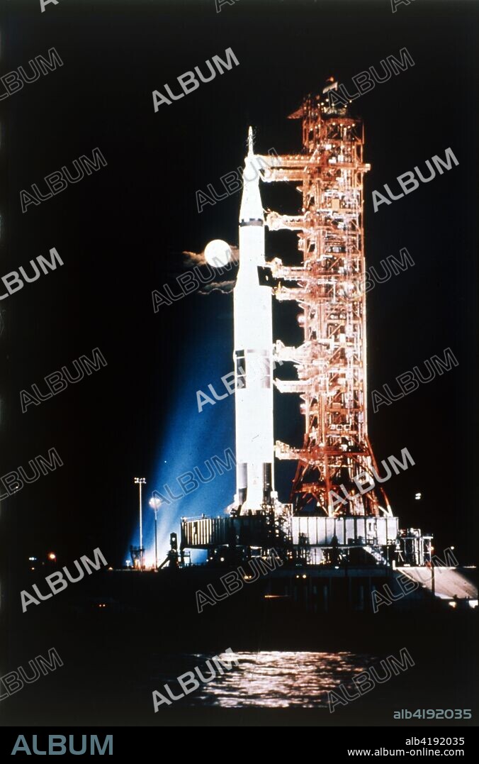 Apollo 9 Saturn V rocket with full moon, 1969. This rocket, shown here on its launch pad at the Kennedy Space Centre, Cape canaveral, Florida, USA, launched Apollo 9 on 3 March 1969, carrying astronauts James McDivitt, David Scott and Russell Schweickart, into earth orbit where they tested the full Apollo moon craft for the first time. The Saturn V was the largest rocket ever built and was used on all Apollo missions to the moon.
