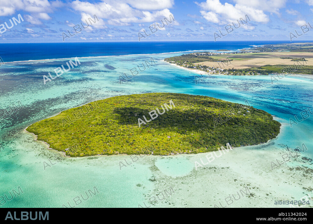 Lush vegetation on Ile aux Aigrettes atoll in the turquoise lagoon, aerial view by drone, Pointe d'Esny, Mahebourg, Mauritius, Indian Ocean, Africa.
