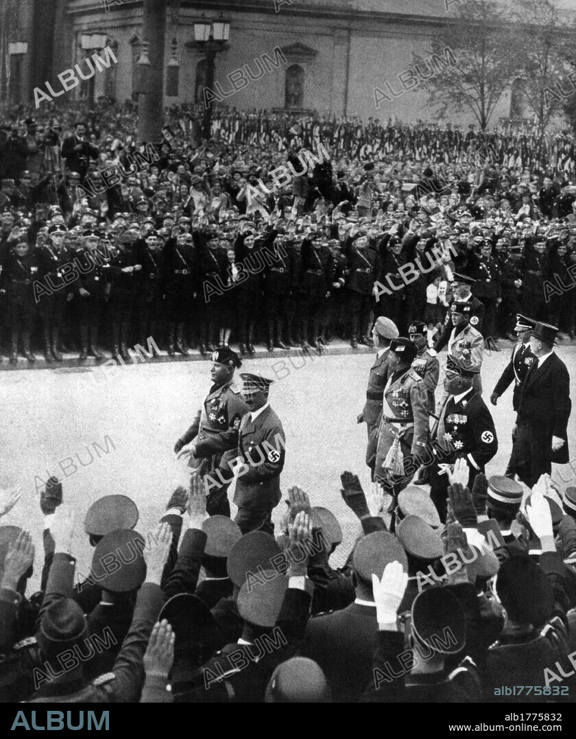 Mussolini and Adolf Hitler in Monaco in front of the war memorial. The head of the government of the kingdom of Italy, Benito Mussolini, and the chancellor of the Third Reich, Adolf Hitler, reviewing Nazi formations in front of a war memorial. Among the others, Konstantin von Neurath, Galeazzo Ciano, Achille Starace, Dino Alfieri. Munich, 25 September 1937.
