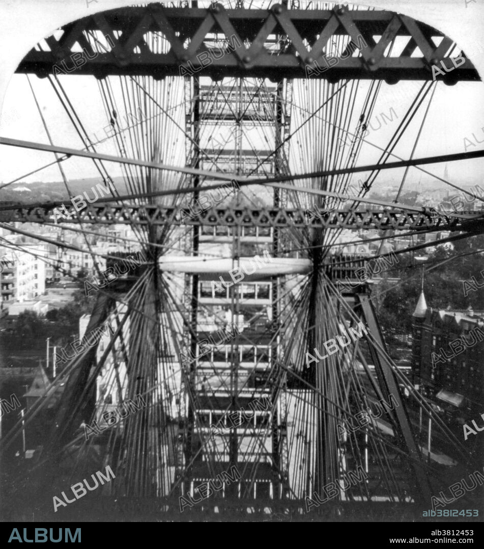 The original Ferris Wheel was the centerpiece of the 1893 World's Columbian Exposition in Chicago, Illinois. The Ferris Wheel was designed and constructed by George Washington Gale Ferris Jr., a graduate of Rensselaer Polytechnic Institute. The wheel rotated on a 71 ton, 45.5 foot axle comprising what was at that time the world's largest hollow forging, manufactured in Pittsburgh by the Bethlehem Iron Company and weighing 89,320 pounds, together with two 16 foot diameter cast-iron spiders weighing 53,031 pounds. There were 36 passenger cars, each fitted with 40 revolving chairs and able to accommodate up to 60 people, giving a total capacity of 2,160. The Ferris Wheel took 20 minutes to make two revolutions, the first involving 6 stops to allow passengers to exit and enter and the second a 9 minute non-stop rotation, for which the ticket holder paid 50 cents. Cropped stereograph by Keystone View Company, 1893.