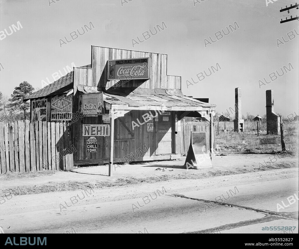 WALKER EVANS. Coca-Cola shack in Alabama. [Signs advertising Ringling Bros and Barnum & Bailey Circus, Coca-Cola, Chero, Nehi, Grove's Chill Tonic, 7Up. Note brick chimney stacks left standing after destruction of timber houses].
