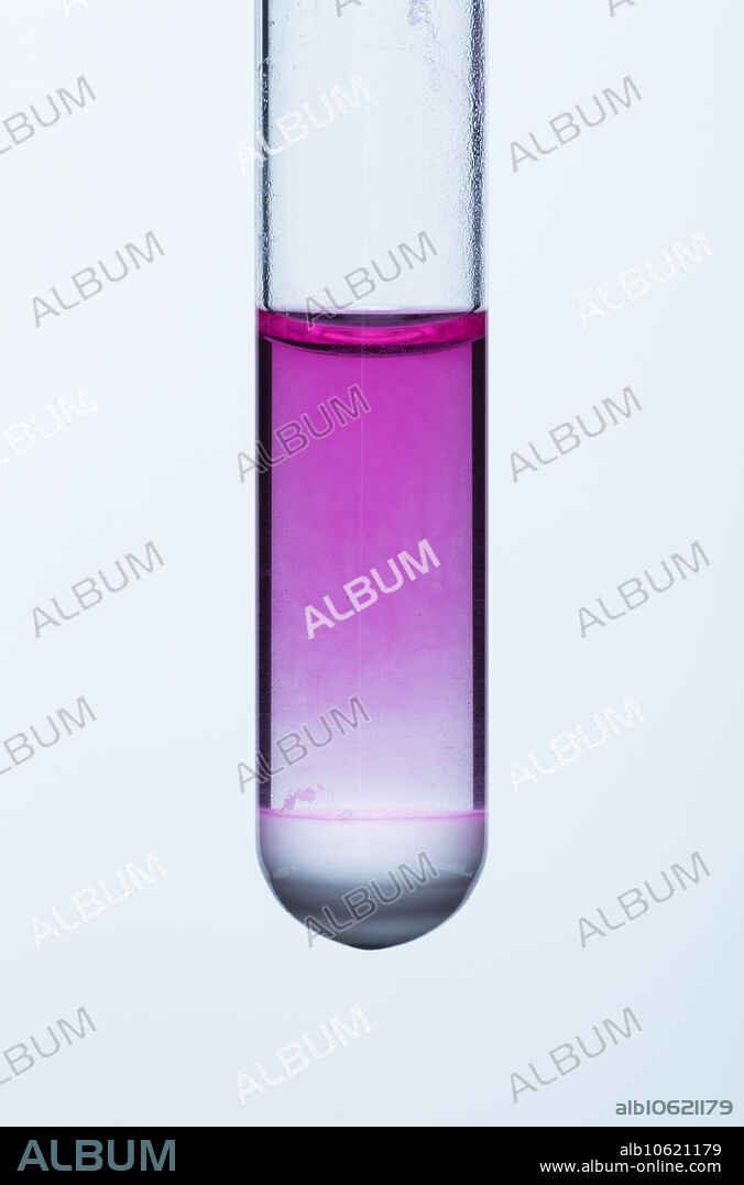 Calcium oxide reacts with water. A small amount of calcium oxide (CaO, quicklime) in a test tube is mixed with water. Calcium hydroxide (Ca(OH)2, hydrated lime or caustic lime or slaked lime) is produced in the exothermic reaction: CaO + H2O -> Ca(OH)2. This process is known as slaking. Calcium hydroxide is poorly soluble in water. It still produces enough hydroxide ions to turn phenolphthalein indicator pink, indicating an alkaline resulting solution.
