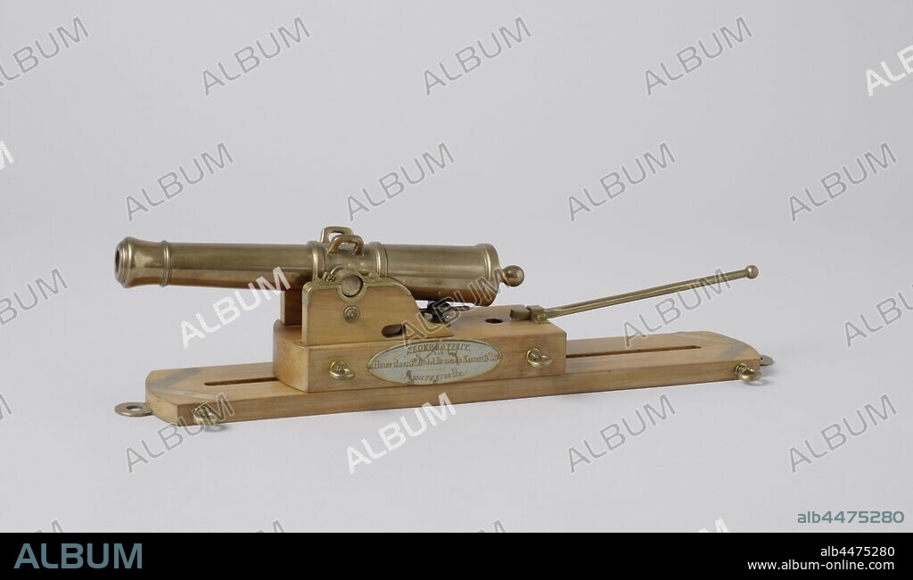 Model of a 3-Pounder Gun on a Slide for a Launch, Model of a cannon on a slide carriage for sloops. The trumpet is tulip-shaped and finished with a jewelry ring. The 28 cm long barrel has a caliber of 14 mm and two jewelery bands, two simple dolphins were cast on the tap piece. There is a grape on the breech. The spout is a thick rectangular board, rounded at the front, and on which two cheeks are connected by a brass rod. The cheeks have elliptical holes at the bottom for the refraction and the taps are covered with brass. The carriage has a swirl bolt that travels into the channel of the carriage, an elevator screw that can be set in two positions, one for howitzer and one for a gun, and a baking iron. The sledge is a long frame with a trench in the middle and is rounded at both ends with an eye for a spindle bolt. Eye bolts are mounted on the corners of the carriage and the carriage. Scale 1: 5 (scale on model)., Rijkswerf Amsterdam, Amsterdam, 1855, wood (plant material), copper (metal), bronze (metal), h 11.5 cm × w 48.2 cm × d 12 cm × h 18 cm w 55.5 cm × d 22 cm.