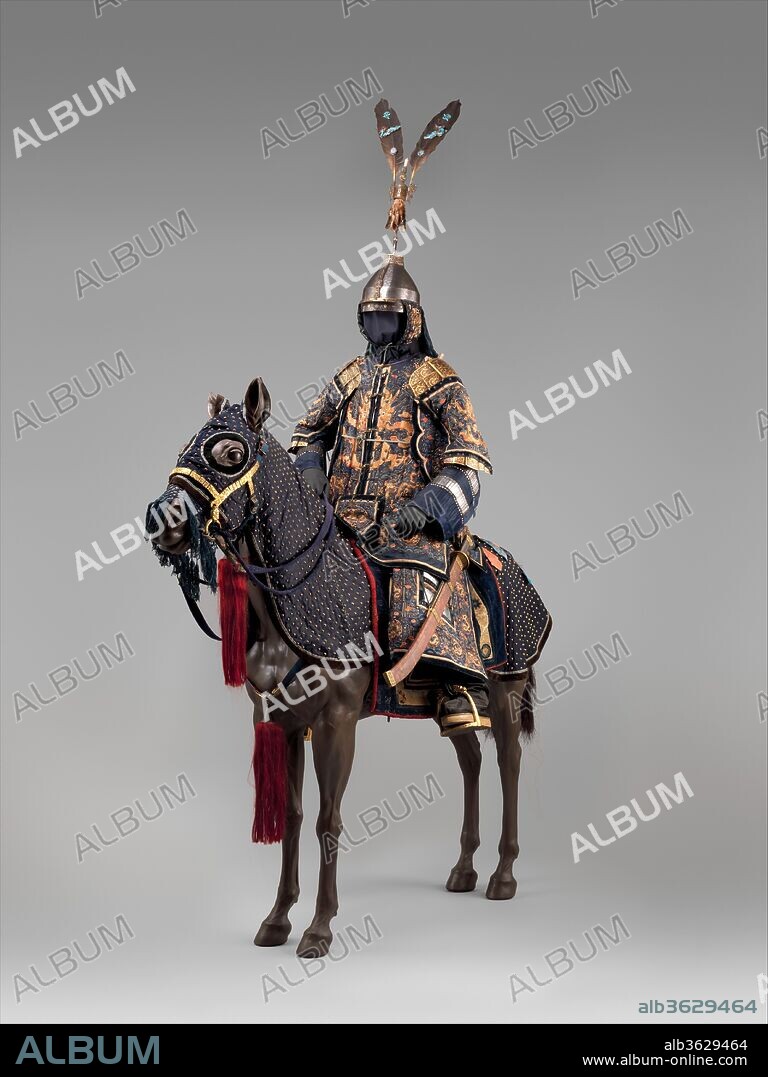 Ceremonial Armors for Man (Dingjia) and Horse. Culture: Chinese. Date: 18th century.
The man's armor, known as dingjia (armor with nails), is a very elaborate example of the military costume worn at the imperial court by high-ranking officials in the eighteenth and nineteenth centuries. It consists of a jacket with sleeves and an ankle-length skirt constructed of narrow overlapping plates riveted inside the fabric layers with the securing rivet heads visible on the outside. Some of these plates, of brightly polished steel, are exposed on the arms and skirt. Although not intended for use in battle, the jacket is reinforced further with large shoulderpieces, panels under the arms, and a small panel of similar construction that covers the lower abdomen. This fashion thus combines the warrior's practical but usually plain armor and the ceremonial robes often worn over it. 
This example is embroidered with gold and colored silk thread, in traditional designs of dragons and waves. The delicately engraved and gilt steel plates at the shoulders repeat these motifs. The helmet is surmounted by a crest of sable tails, coral, and kingfisher feathers mounted with cloisonné enamels. The horse armor has no internal plates but only the rivet heads to give the outward appearance of armor.