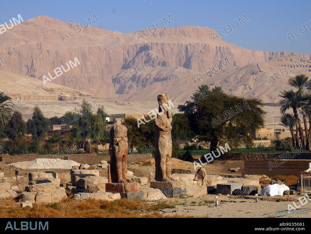 Statues of Amenhotep III at the Mortuary Temple of Amenhotep III, also known as Kom el-Hettân, built by the architect Amenhotep, son of Habu, for the Pharaoh Amenhotep III (or Amenhetep III) during the 18th Dynasty in the New Kingdom. The mortuary temple is located on the Western bank of the Nile river, across from the Eastern bank city of Luxor.