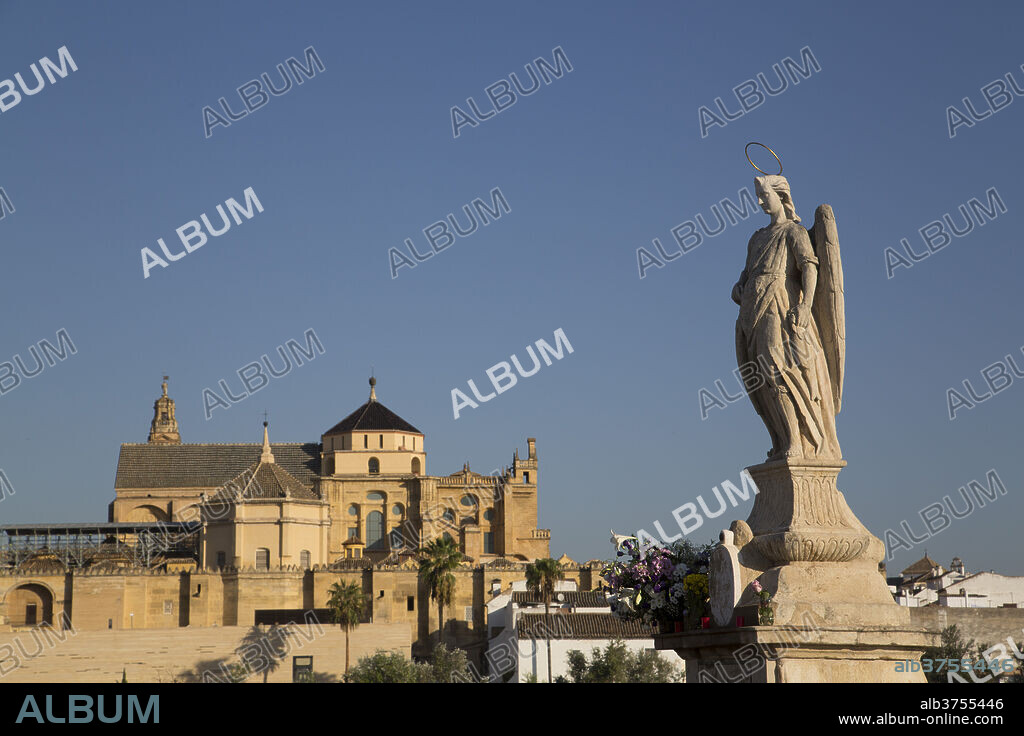 Statue of Raphael the Archangel with the Great Mosque (Mesquita) and Cathedral of Cordoba in the background, Cordoba, Andalucia, Spain, Europe.