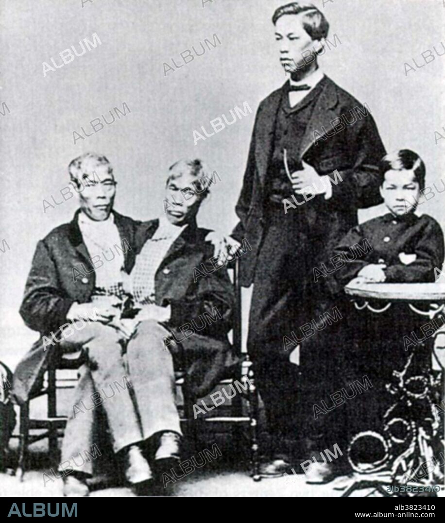 Chang and Eng Bunker with their sons; Eng's son James (age 21) and Chang's son Albert (age 12). Chang and Eng (May 11, 1811 - January 17, 1874) were conjoined twin brothers whose condition and birthplace (Siam, now Thailand) became the basis for the term "Siamese twins." The brothers were born on May 11, 1811, joined at the sternum by a small piece of cartilage. Their livers were fused but independently complete. In 1829, they were "discovered" in Siam by British merchant Robert Hunter and toured the world as a curiosity. Upon termination of their contract they were determined to start living a normal life as much as possible. They became naturalized United States citizens, settled on a plantation in North Carolina, bought slaves and adopted the last name "Bunker". The twins died on the same day in January 1874. Chang, who had contracted pneumonia, died rather suddenly in his sleep. Eng awoke to find his brother dead, and called for his wife and children to attend to him. A doctor was summoned to perform an emergency separation, but Eng refused to be separated from his dead brother. He died three hours later. Photographed by Samuel Masury, 1870.
