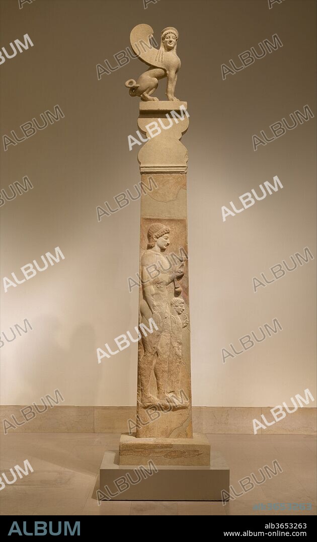 Marble stele (grave marker) of a youth and a little girl. Culture: Greek, Attic. Dimensions: total H. 166 11/16 in. (423.4cm). Date: ca. 530 B.C..
Inscribed on the base: to dear Me[gakles], on his death, his father with his dear mother set [me] up as a monument
This is the most complete grave monument of its type to have survived from the Archaic period. Fragments were acquired by The Metropolitan Museum of Art in 1911, 1921, 1936, 1938, and 1951. The fragment with the girl's head, here a plaster copy, was acquired in 1903 by the Berlin Museums; the fragment with the youth's right forearm, also a plaster cast here, is in the National Museum in Athens. The capital and crowning sphinx are casts of the originals, displayed in a case nearby.  
The youth on the shaft is shown as an athlete, with an aryballos (oil flask) suspended from his wrist. Athletics were an important part of every boy's education, and oil was used as a cleanser after exercise. He holds a pomegranate--a fruit associated with both fecundity and death in Greek myths--perhaps indicating that he had reached puberty before his death. The little girl, presumably a younger sister, holds a flower. 
This exceptionally lavish monument, which stands over thirteen feet high, must have been erected by one of the wealthiest aristocratic families. Some scholars have restored the name of the youth in the inscription as Megakles, a name associated with the powerful clan of the Alkmeonidai, who opposed the tyrant Peisistratos during most of the second half of the sixth century B.C. The tombs of aristocratic families were sometimes desecrated and destroyed as a result of that conflict, and this stele may well have been among them.