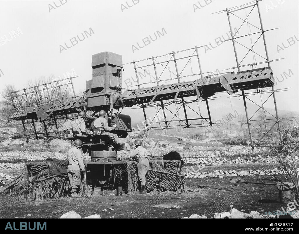 A five man crew operates the SCR-268 radar system used for controlling anti-aircraft gunfire during World War II, 1944.
