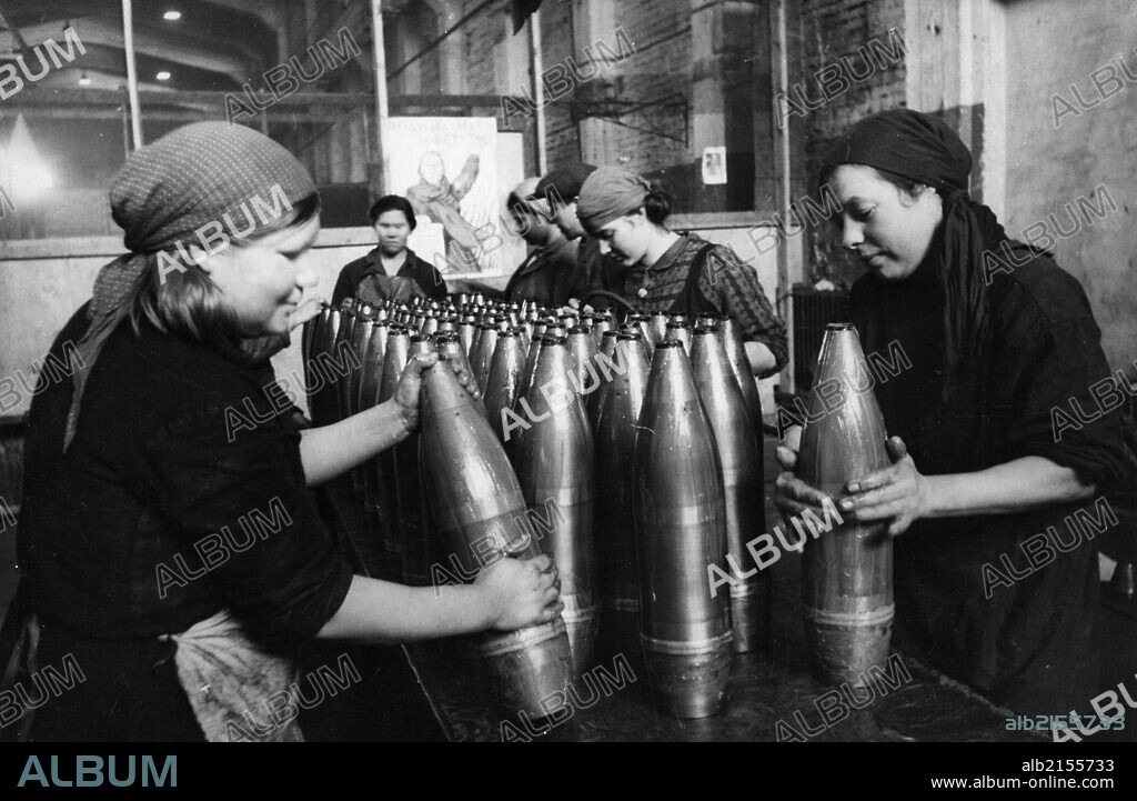 A team of civilian women packers putting grease onto artillery shells at a munitions factory during world war 2. 01/02/2013