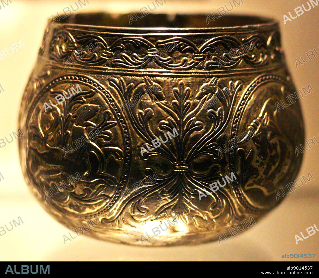 Decorative Viking hoard cups. (Named the Vale of York cup and the Halton Moor Cup) Made from gold and silver. Decorated with animals and foliate patterns. Found buried in England. Were buried shortly after AD 927.