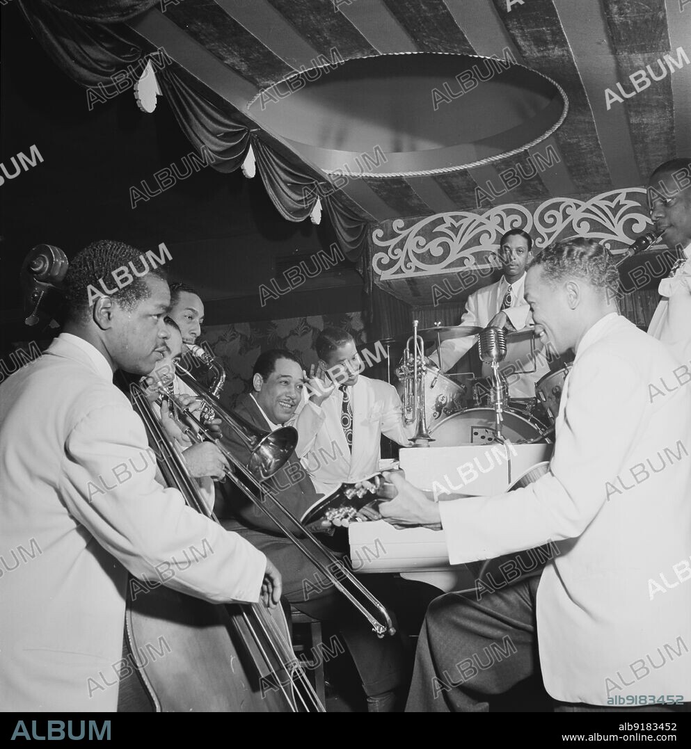 WILLIAM PAUL GOTTLIEB. Portrait of Junior Raglin, Lawrence Brown, Johnny Hodges, Duke Ellington, Ray Nance, Sonny Greer, Fred Guy, and Harry Carney, Aquarium, New York, N.Y., ca. Nov. 1946.