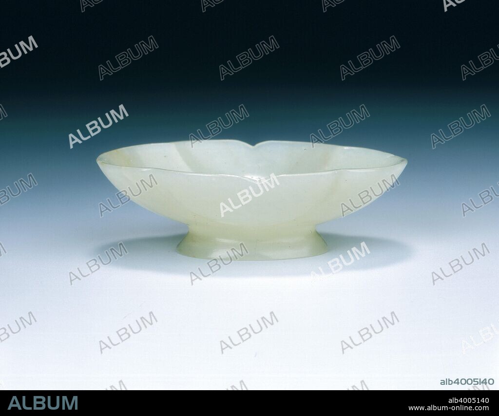 Celadon jade lobed oval cup, late Tang-early Liao dynasty, China, 9th-11th century. A lobed jade cup of oval shape divided into three curving sections. The shape is in imitation of 9th century metallic form with scalloped rim and high spreading foot.