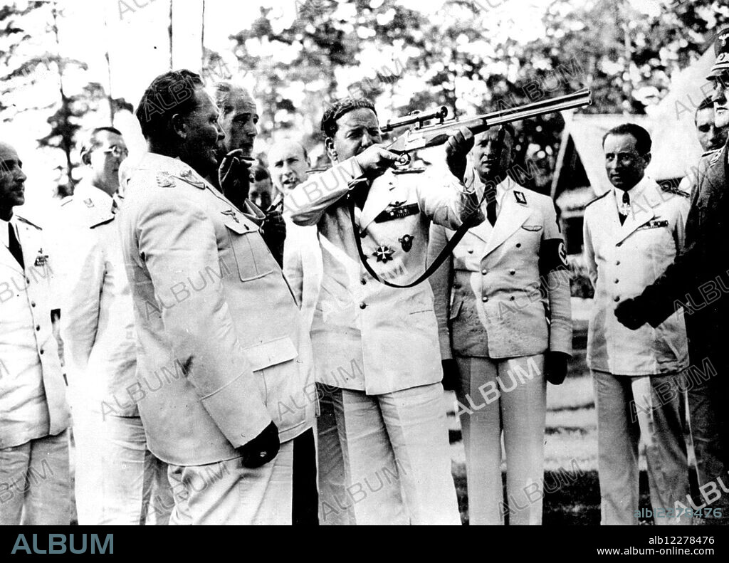 Marshal Balbo Visits Goering's Hunting ***** - Marshal Balbo tries out a gun, watched by Field-Marshal Goering.Marshal Balbo, governor-general of Libya, who is visiting Germany as the guest of Field-Marshal Goering, yesterday visited Goering's hunting lodge, Karinhall. January 1, 1938. (Photo by Keystone).