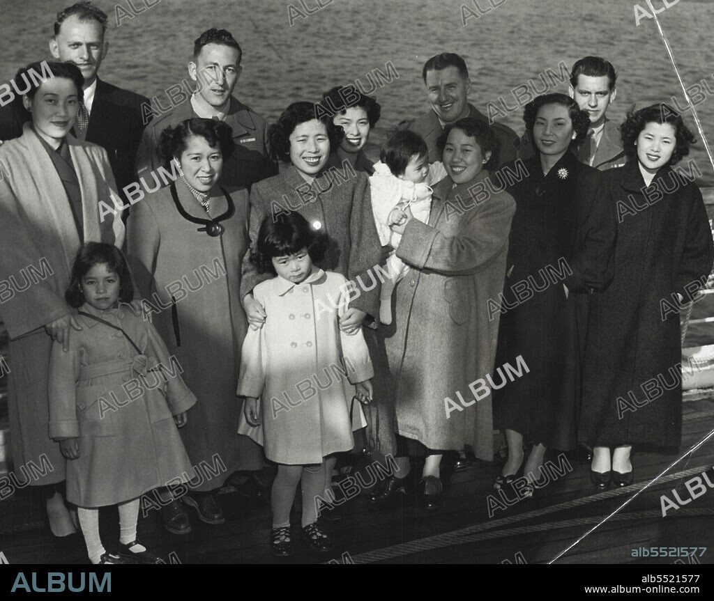 Seven Japanese wives who arrived on the Changte to-day are Mrs. L. Lutz and wife Takako with daughter Reiko (5 1/2) Lance Cpl B. O'Grady and wife Kazuko.Mrs. Time Barnes (Back Row), Mrs. Gutland with daughter Noriko (9), Mrs. Akiko Kirkham with Patrica (8mnths), W/O I. Andrew and wife Tomiko Staff Sergeant Len Weston with wife Kazue. Nine Japanese wives arrived on the ship. July 29, 1953.