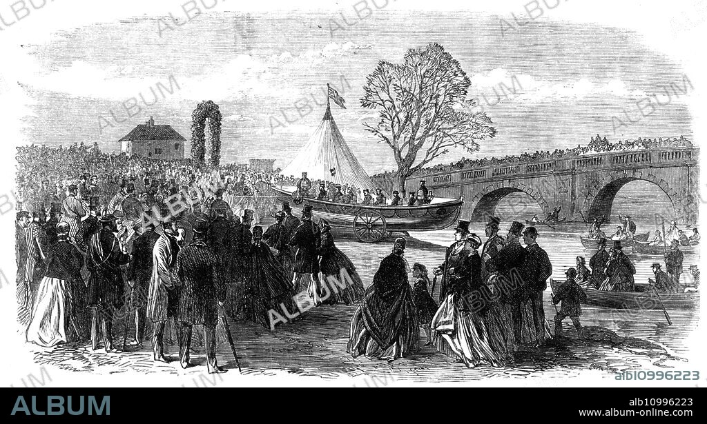 Lady Houghton naming the Pontefract and Goole Life-Boat, Ferrybridge, Knottingley, Yorkshire, 1865. 'The new life-boat...was named by Lady Houghton, and launched in the waters of the Aire and Calder Navigation...The Mayor and Corporation...with some of the principal inhabitants of the town...[formed a procession. They were] followed by the united bands of the West York Rifle Militia and the Pontefract Volunteer Corps; the crew who were to man the boat consisting of a dozen smart fellows from Knottingley in cork jackets, and picturesquely adorned with ribbons; the rifle corps, the borough police, the Mayor, and the Rev. Dr. Bisset, the Vicar designate; the Rev. Sir T. Blomefield, the Rev. S. W. Newbald, the Town Clerk, many of the Town Council, borough magistrates, and others; the procession being closed by the children of the town schools...the launch took place near the bridge...the Rev. Dr. Bisset read a psalm and a prayer, and pronounced a benediction on the boat; and Lady Houghton then, in a gracefully-worded address, named the boat "The Pomfret and Goole." The blocks being knocked aside, the vessel glided easily, rapidly, and gracefully into the water, amid the cheers of the thousands of assembled spectators and the firing of cannon'. From "Illustrated London News", 1865.