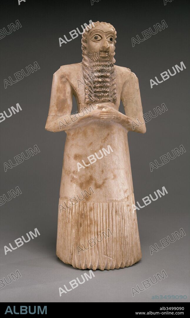 Standing male worshiper, Early Dynastic I-II, ca. 2900–2600 B.C., Mesopotamia, Eshnunna (modern Tell Asmar), Sumerian, Gypsum alabaster, shell, black limestone, bitumen, 11 5/8 x 5 1/8 x 3 7/8 in. (29.5 x 12.9 x 10 cm), Stone-Sculpture, In Mesopotamia gods were thought to be physically present in the materials and experiences of daily life. Enlil, considered the most powerful Mesopotamian god during most of the third millennium B.C., was a 'raging storm' or 'wild bull,' while the goddess Inanna reappeared in different guises as the morning and evening star.