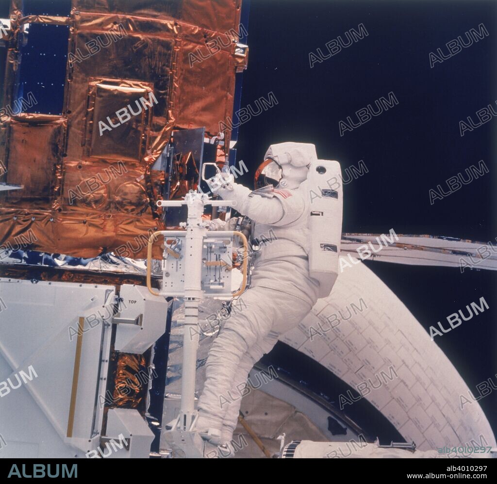 Astronaut on Shuttle mission 41-C, 1984. Shuttle astronaut with Solar Maximum Satellite in the hold of the Space Shuttle Challenger. During Shuttle mission 41-C, launched on 6 April 1984, astronauts George Nelson and James van Hoften captured the Solar Maximum Satellite that had failed in orbit four years before, took it back to Challenger where they repaired and released it again. This was the first repair of a satellite in space. The astronauts also flight-tested Manned Manoeuvering Units (MMUs) and operated the Cinema 360 and IMAX Camera Systems.