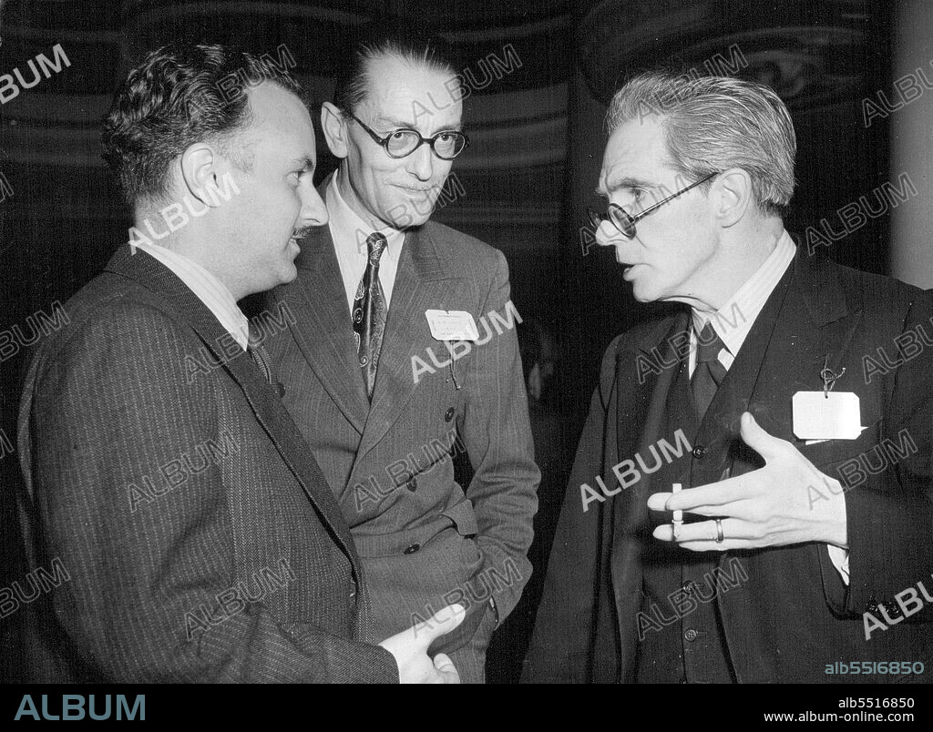 They Will Talk Of Flights To The Moon -- Senor T. Mur (Spain), Mr. R.A. Smith (British Interplanetary Society) and Professor A.M. Low, the well-known British scientist, chatting together during a reception in connection with the Second International Congress on Astronautics convened by the British Interplanetary Society. Fifty scientist most of them working on rocket research, and plans for flights to ***** the Moon, are attending. September 3, 1951.