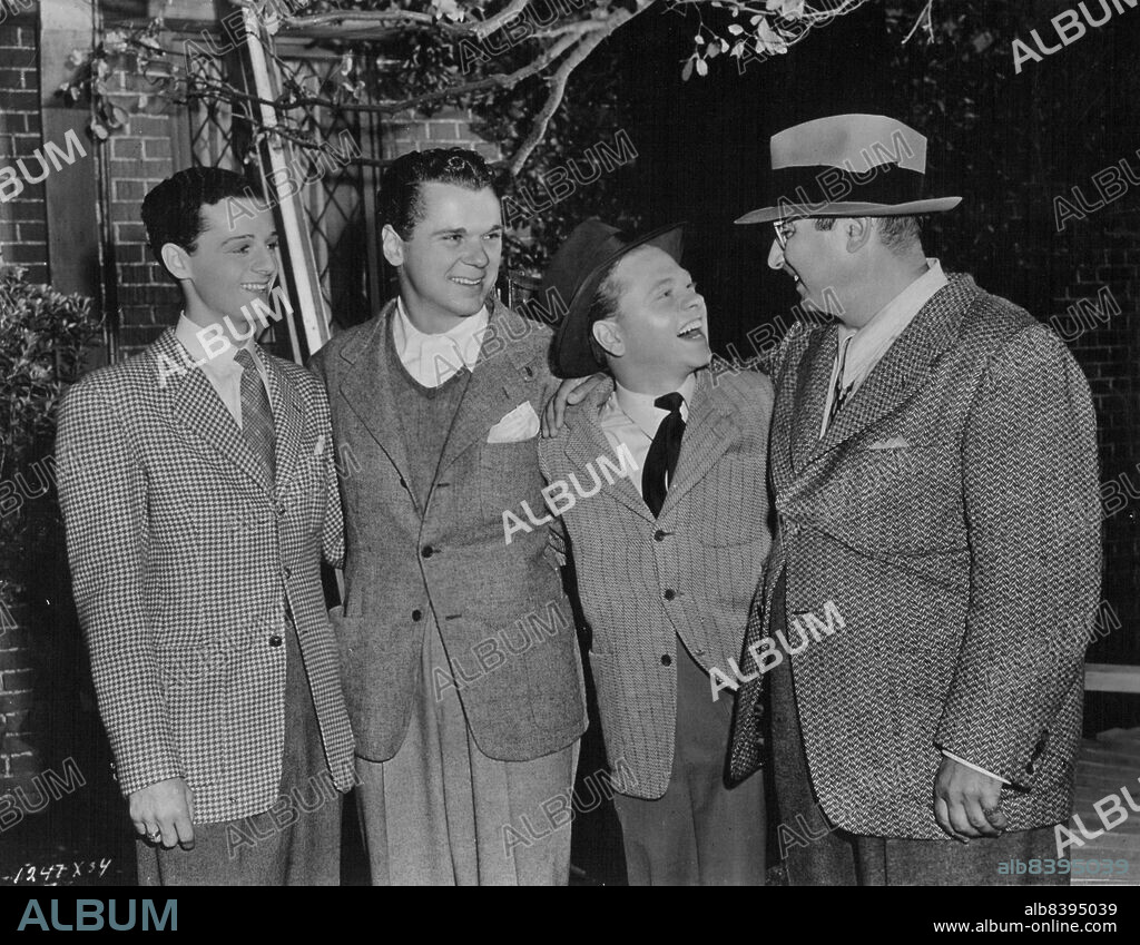 Norman Taurog - "Uncle Norman" to the dozens of Screen juveniles he has directed - chats with Freddie Bartholomew, his nephew Jackie Cooper, and Mickey Rooney. The youngsters come to him for advice whenever they contemplate one of their frequent shows for war relief. November 5, 1947.