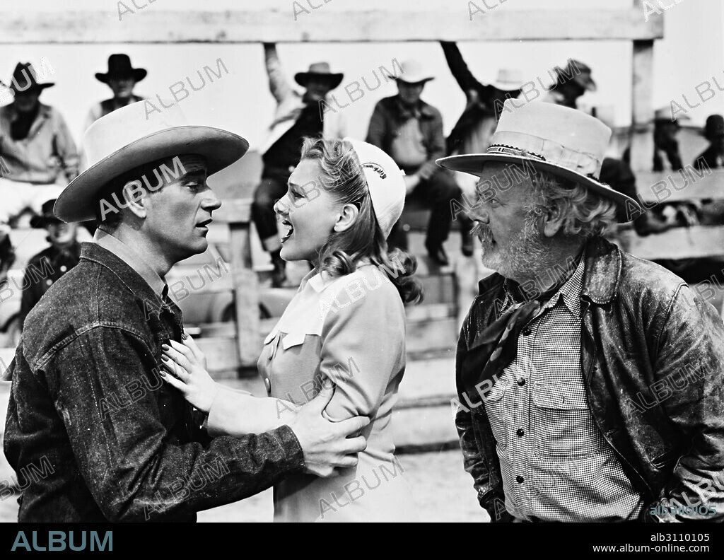 CHARLES WINNINGER, JEAN ARTHUR and JOHN WAYNE in A LADY TAKES A CHANCE, 1943, directed by WILLIAM A. SEITER. Copyright RKO.
