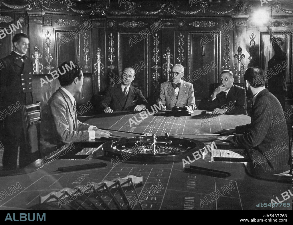 Having successfully passed the medical test, candidates appear before a board of directors. Photo shows two candidates being examined by Mr. Joseph Ferre. Director of the Personnel (centre) assisted by Mr. Pierre Limon, General Secretary of the Games Department (on his right) and by Mr. Andre Lauri, Assistant of the Games Department. Candidates pass first a stringent medical test (with particular attention to eyesight), then are interviewed by the board of examiners who look for personality, int.