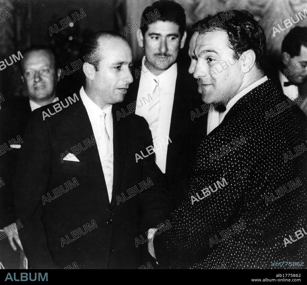 Juan Manuel Fangio meeting Rocky Marciano. Argentine driver Juan Manuel Fangio meeting American boxer Rocky Marciano with his manager Marcello Giambertone and Cuban Sports Minister Juan Miranda. Miami,  1957.