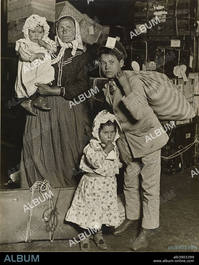 LEWIS HINE. Immigrant Family in the Baggage Room of Ellis Island. Date/Period: 1905. Gelatin silver print. Width: 19.1 cm. Height: 24.1 cm (sheet).