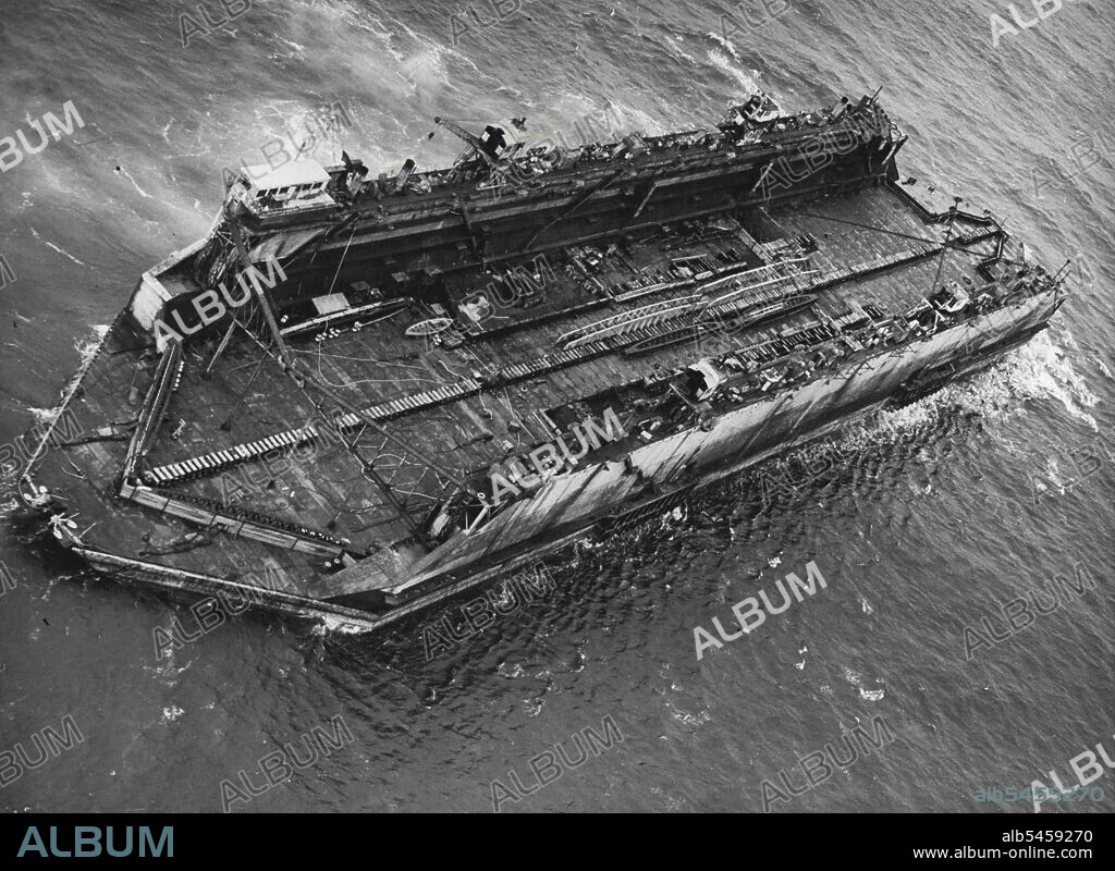 Bermuda Floating Dock Nears Britain -- Aerial view of the floating dock in the Atlantic Ocean, 400 miles off the English Coast.The largest "Chunk" of H.M.S. Malabar, the Navy's name for its Bermuda Dockyard which was closed last March, is being brought back to Britain. Last evening, Aug. 7, it was sighted 400 miles off the English Coast, heading for Falmouth.This huge floating dock is capable of taking up to 14,000 tons of shipping at a time. Its sea trip of 2,500 miles, begun early in July, was an operation undertaken by there of the Navy's most powerful tugs, H.M. Tugs "Reward", "Warden" and "Prosperous". August 08, 1951. (Photo by Paul Popper, Paul Popper Ltd.).